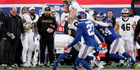 Derek Carr flying through the air 