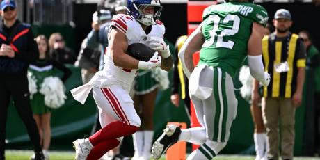 Cam Skattebo rushes against the Eagles