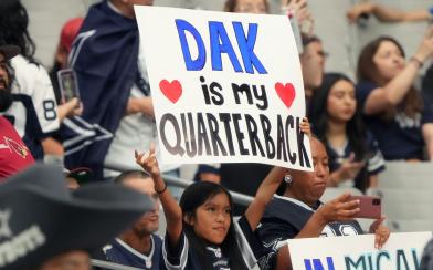 cowboys fan holding sign 