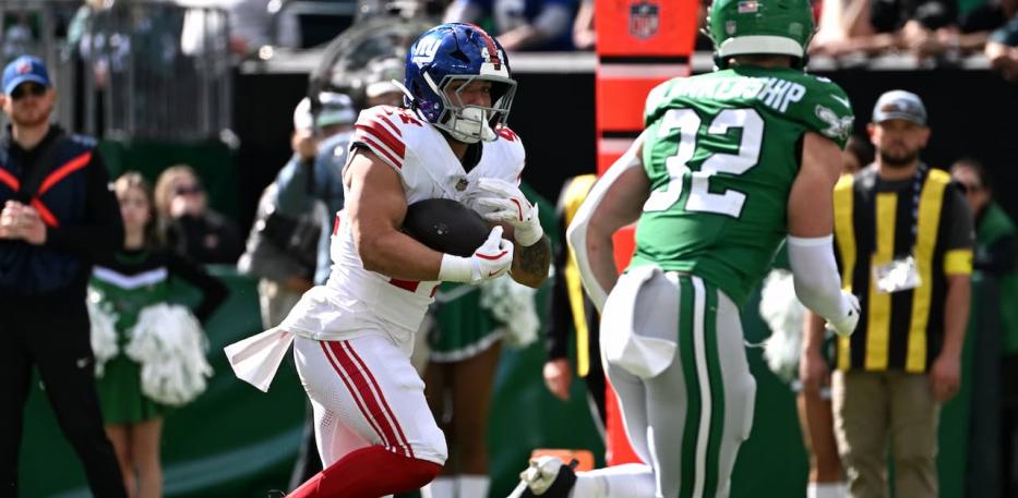 Cam Skattebo rushes against the Eagles