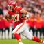 travis kelce running red jersey