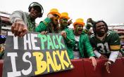 green bay packers fans with a sign 