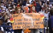 cowboys fans with thanksgiving sign 