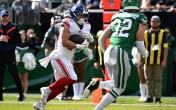 Cam Skattebo rushes against the Eagles